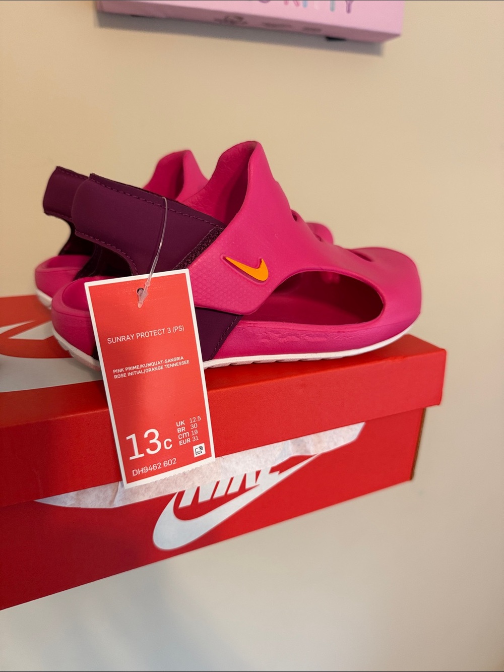 Nike Kids Pink and Purple Sunray Sandals with orange Swoosh